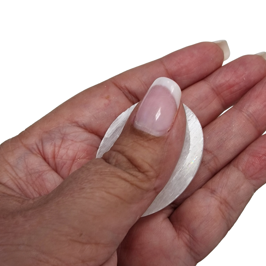Selenite Worry Stone crystal shown on hand for scale.