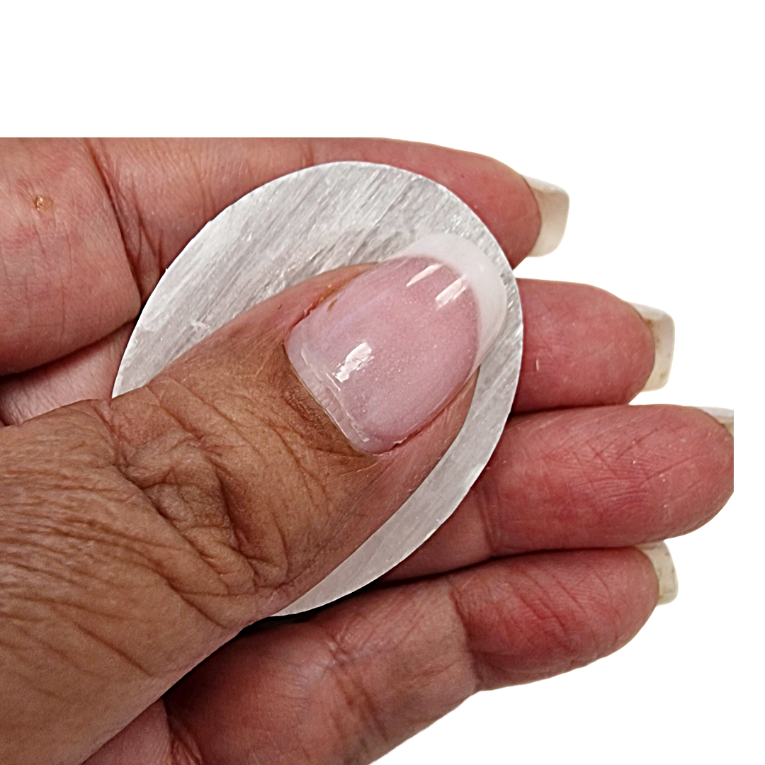 Selenite Worry Stone crystal shown on hand for scale.