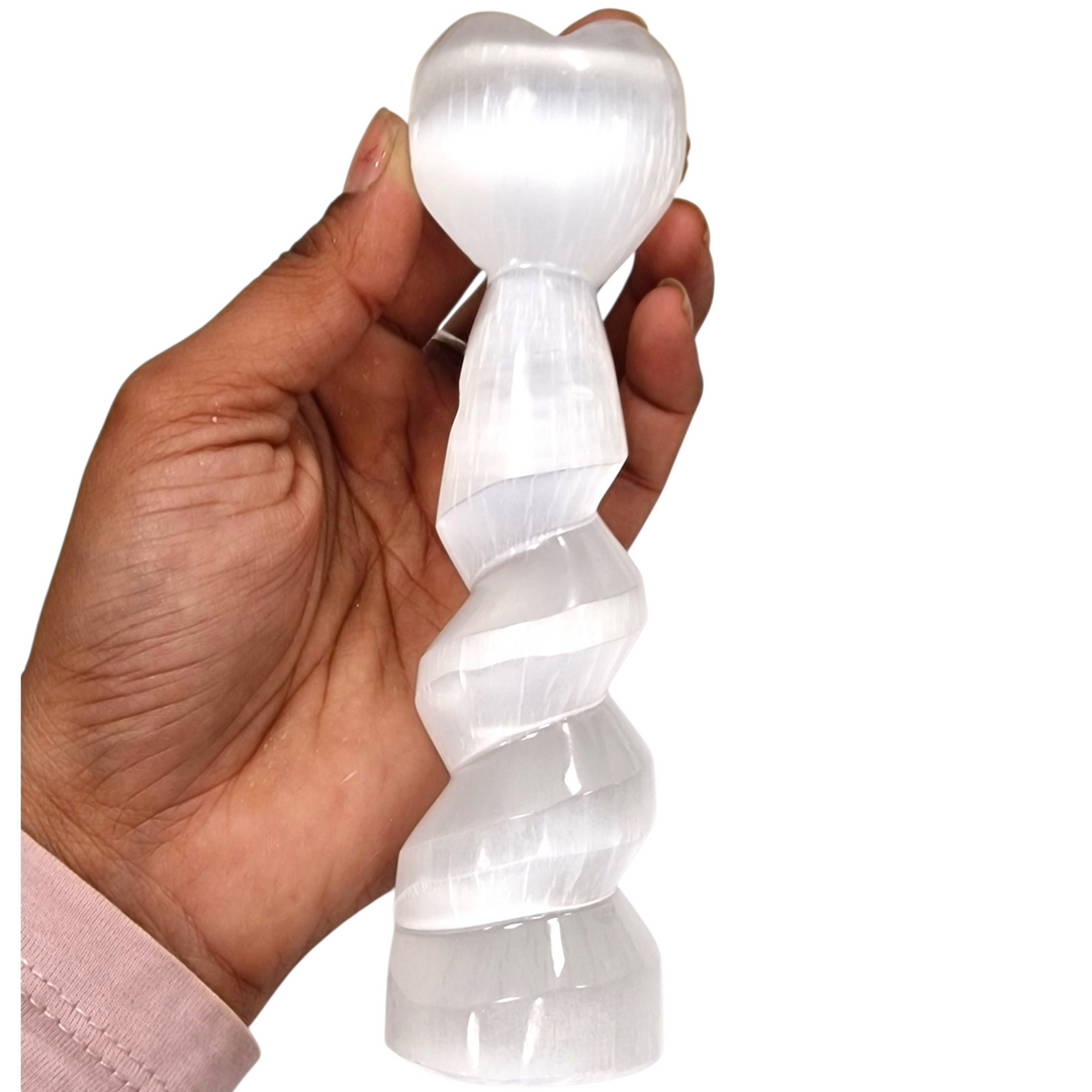 Selenite Spiral Heart Tower 15 cm shown on hand for scale with white background.
