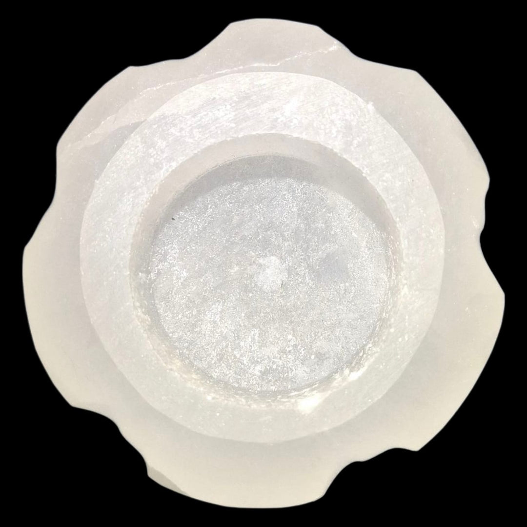 Selenite Sun Tealight Holder in a radiant sun shape, glowing with light and energy for clarity, confidence, and warmth.
