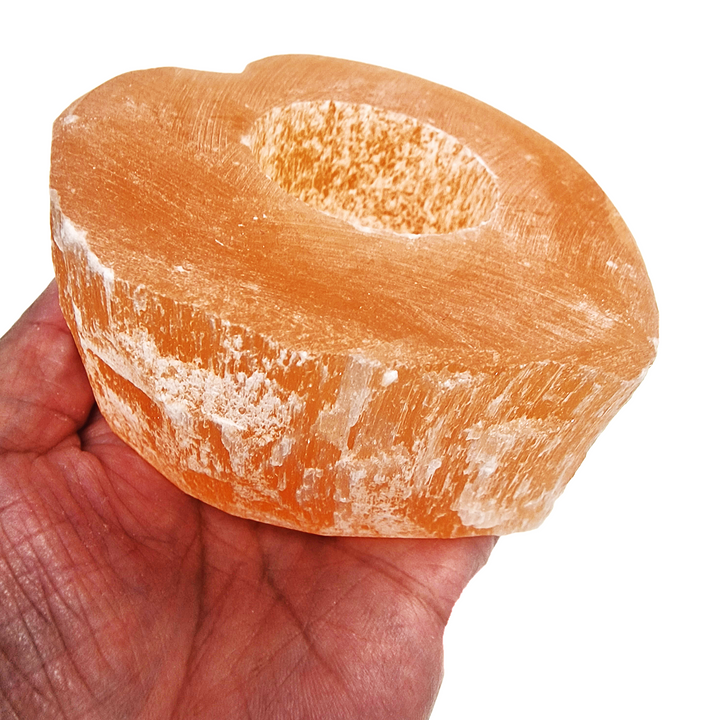 Peach Selenite Heart Tea Light Holder shown in hand for scale.