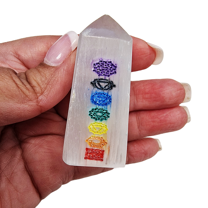 Selenite Chakra Tower 5cm polished mini tower shown on hand for scale.