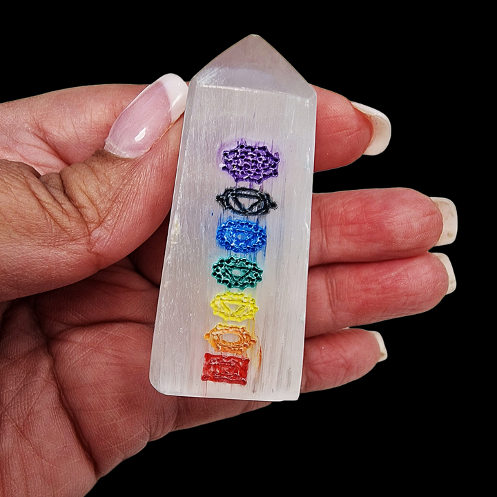 Selenite Chakra Tower 5cm polished mini tower shown on hand for scale.