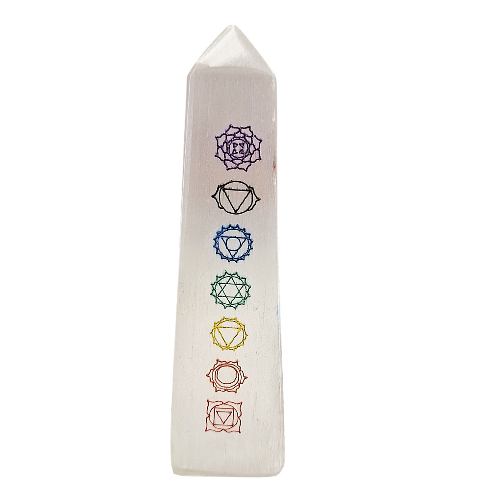 Selenite Chakra Tower 12cm polished with 7 chakra symbols engraved, shown on white background.