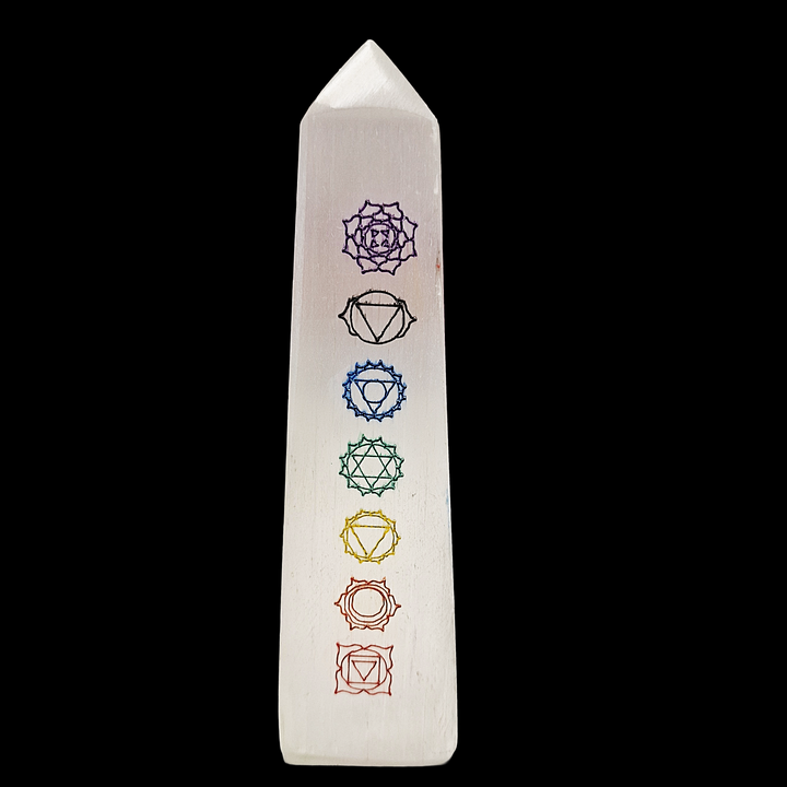 Selenite Chakra Tower 12cm polished with 7 chakra symbols engraved, shown on black background.