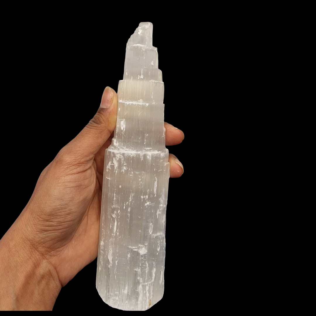 Selenite Tower 20 cm shown on hand for scale.