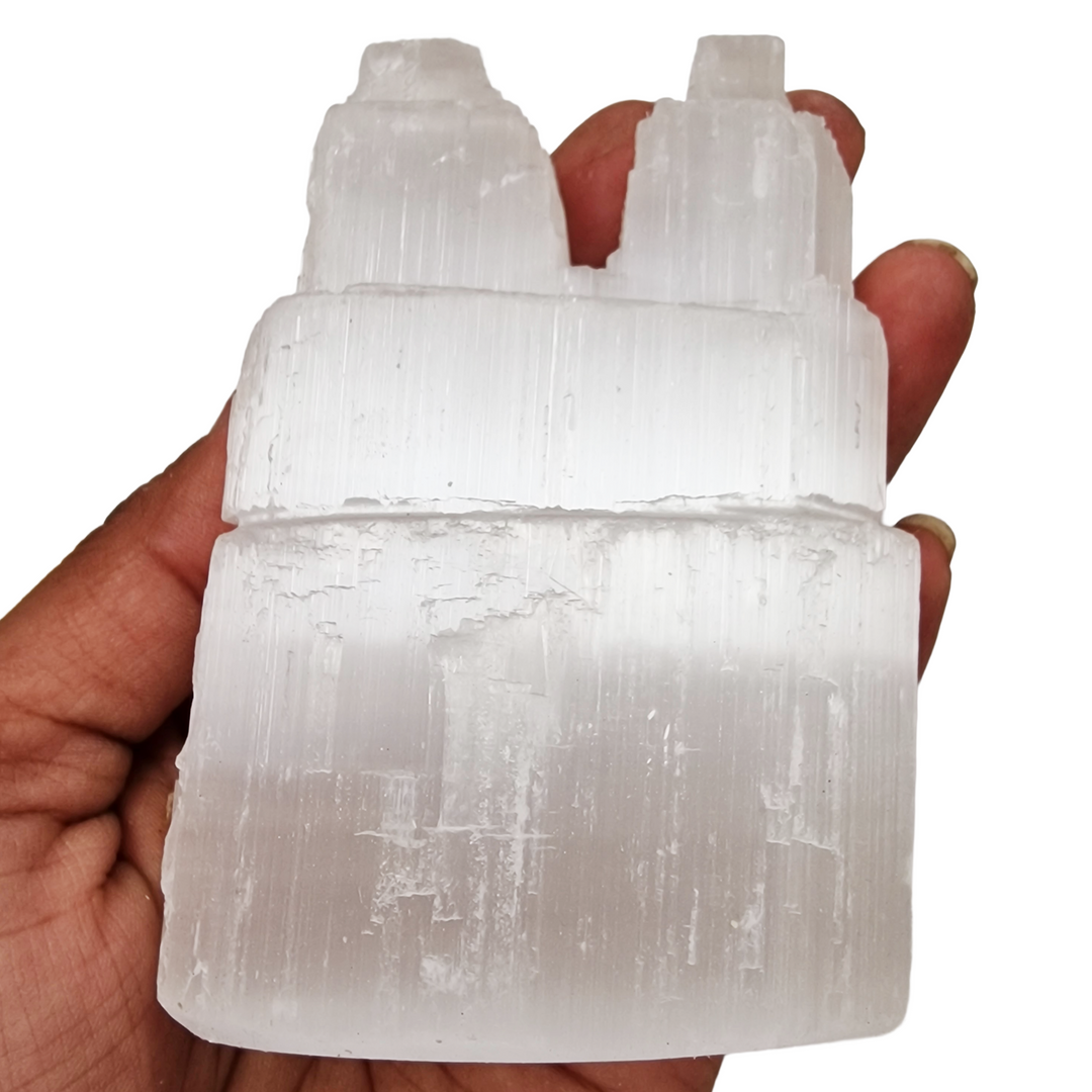 Selenite Twin Peak Tower 10 cm Natural Finish shown on hand for scale.