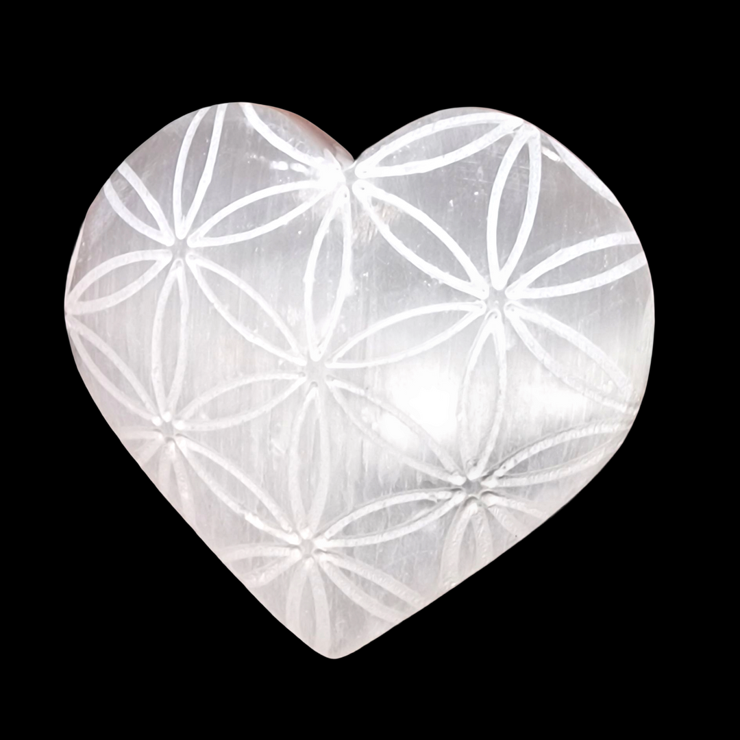 Selenite Flower of Life Engraved Heart 5 cm shown on black background.