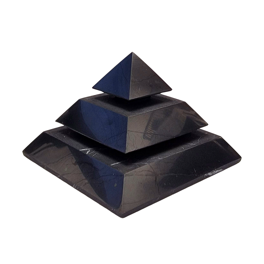 Side view of Saqqara Shungite Pyramid 50mm on white background, shungite crystal for grounding and EMF shielding