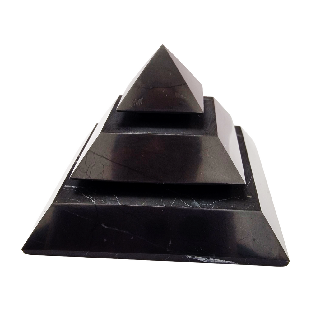 Saqqara Shungite Pyramid 50mm on white background, sacred geometry design for meditation and energy flow