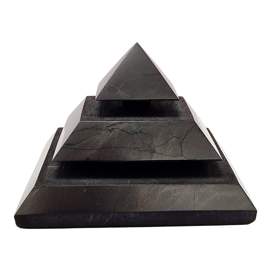 Saqqara Shungite Pyramid 40mm on white background, sacred geometry design for meditation and energy flow