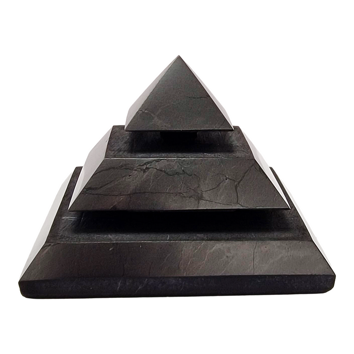 Saqqara Shungite Pyramid 40mm on white background, sacred geometry design for meditation and energy flow