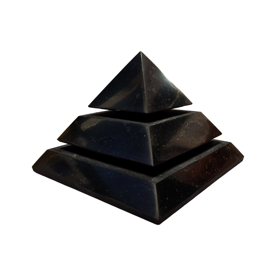 Side view of Shungite 70mm Saqqara Pyramid on white background, grounding crystal for purification and EMF shielding