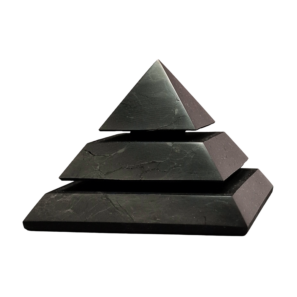 Shungite 70mm Saqqara Pyramid on white background, sacred geometry design for meditation and energy alignment