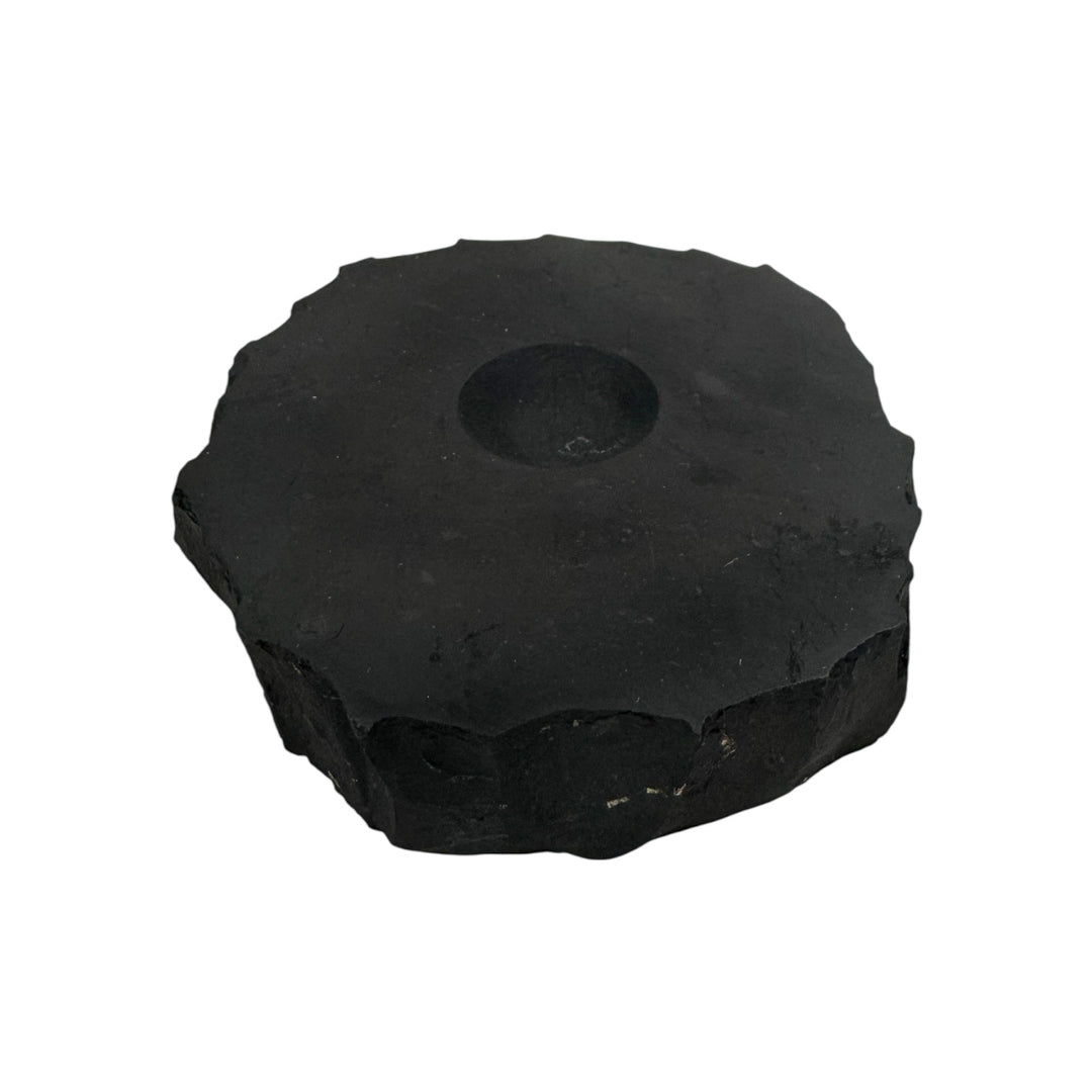 Large shungite base with smooth carved center, used for crystal sphere stands and EMF shielding.