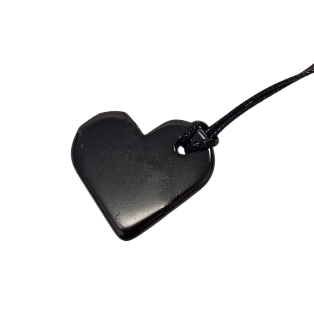 Heart Shungite pendant on white background, polished 30mm crystal for emotional healing and grounding