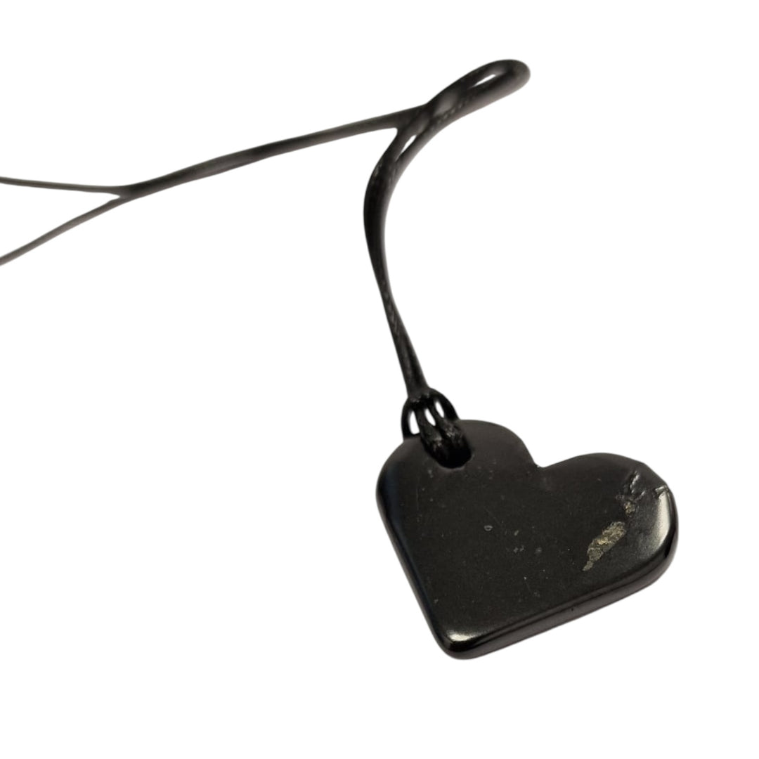 Heart Shungite pendant on white background, polished 30mm crystal for emotional healing and grounding