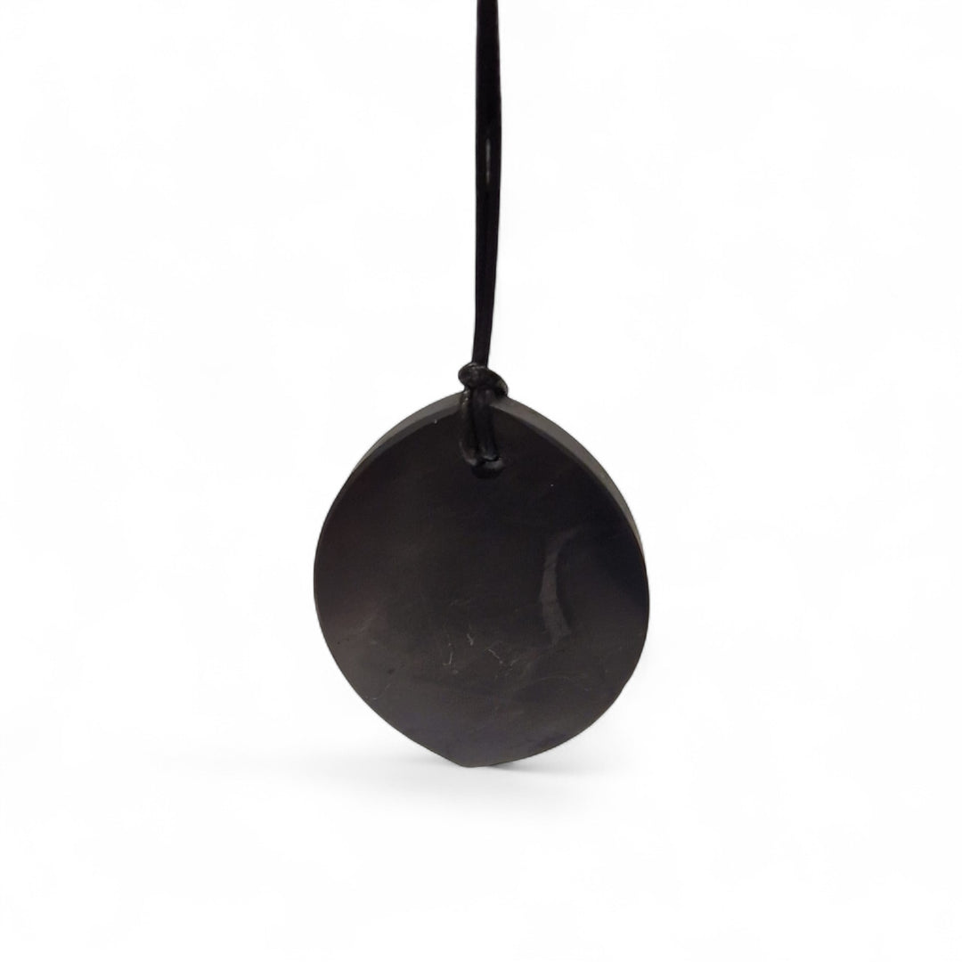 Marquis Shungite pendant displayed on modern bedside table for grounding and EMF shielding