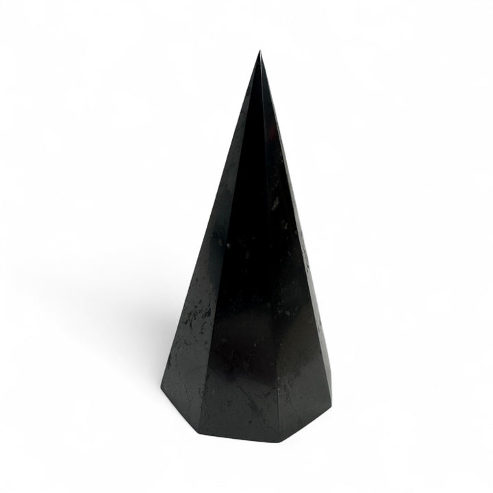 Polished 10cm octagonal shungite pyramid with smooth, reflective black surface, photographed on a white background.