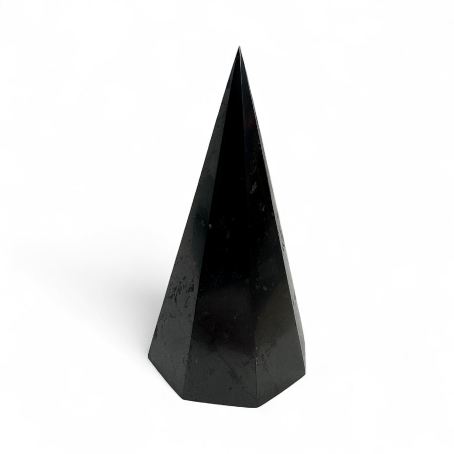 Polished 10cm octagonal shungite pyramid with smooth, reflective black surface, photographed on a white background.