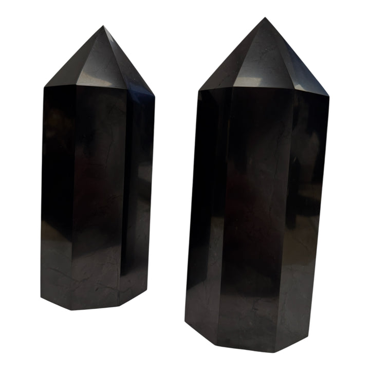 Pair of large polished shungite towers, approximately 20cm, used for powerful energy balancing and space cleansing.