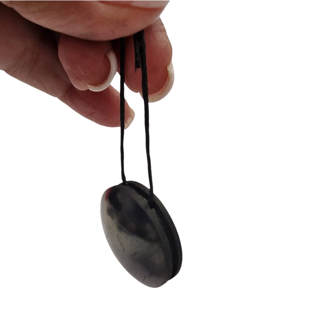 Close-up of Yo-Yo style Shungite pendant showing balanced rounded shape and polished finish