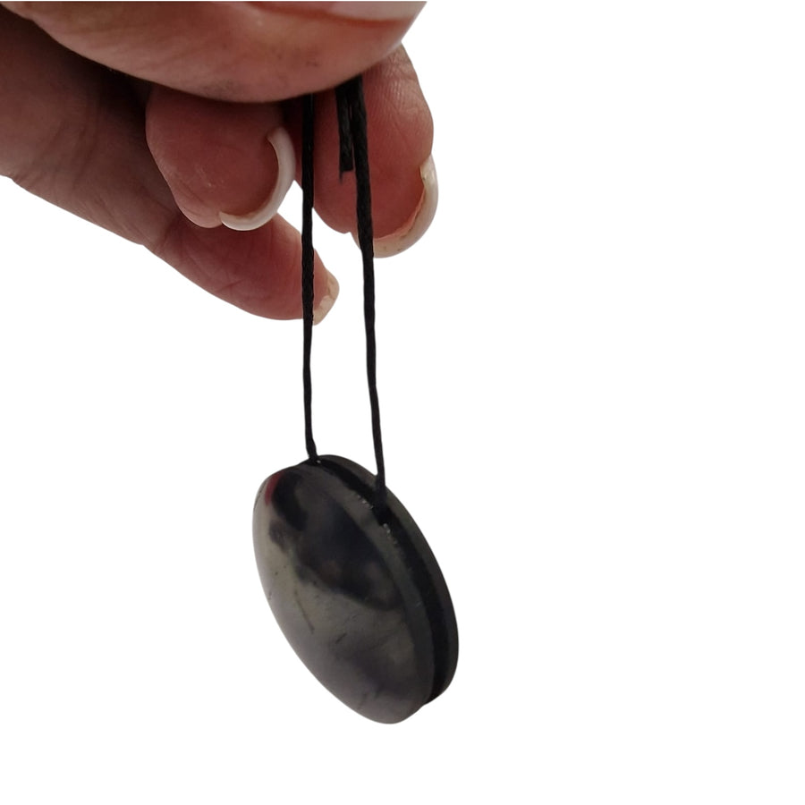 Close-up of Yo-Yo style Shungite pendant showing balanced rounded shape and polished finish