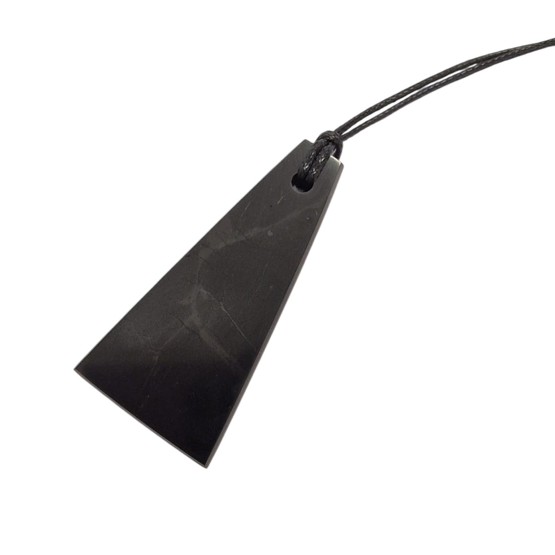 Trapezoid Shungite pendant on white background, polished crystal with cotton cord necklace