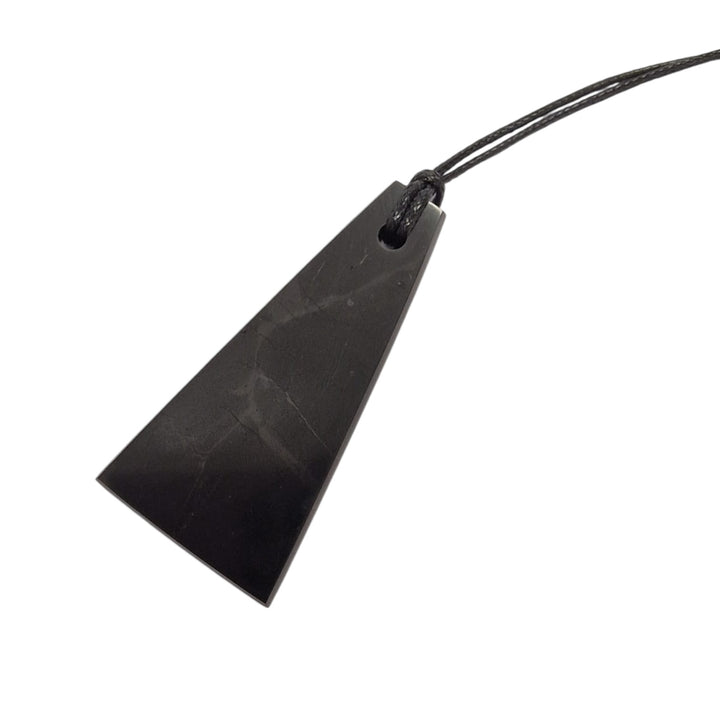 Trapezoid Shungite pendant on white background, polished crystal with cotton cord necklace