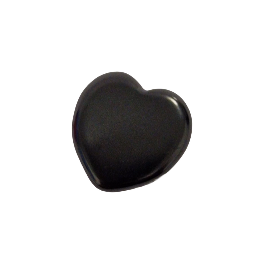 Close-up of Shungite 30mm heart on wooden desk, minimalistic setting for energy harmonisation