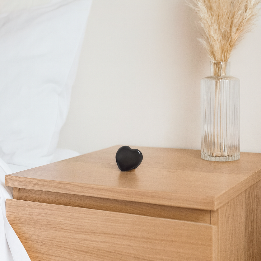 Shungite 30mm heart displayed on bedside table in modern calming home environment