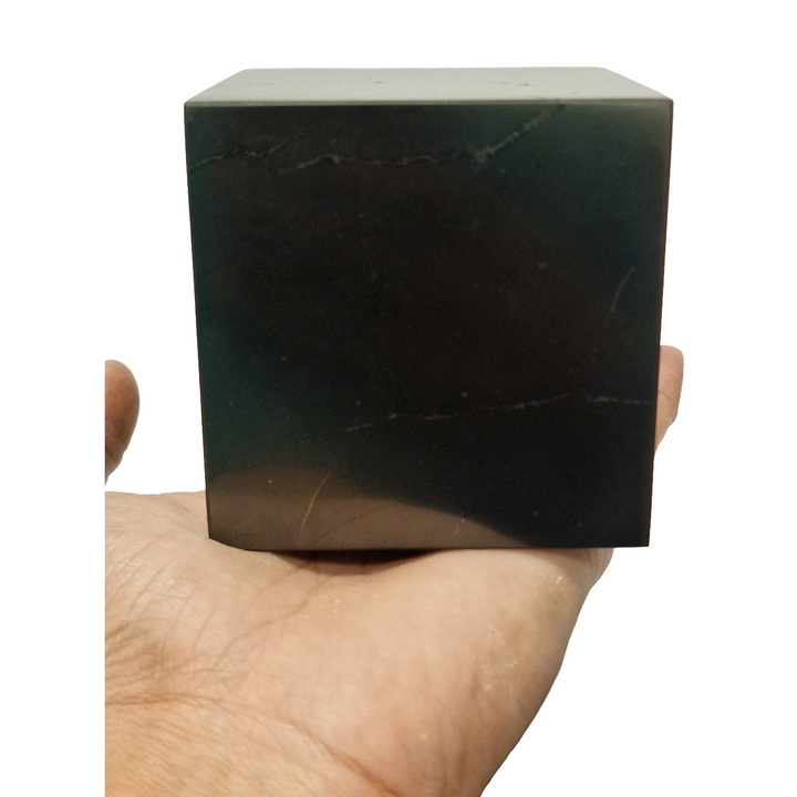 Shungite 70mm Cube on hand for size reference, grounding and EMF protection crystal
