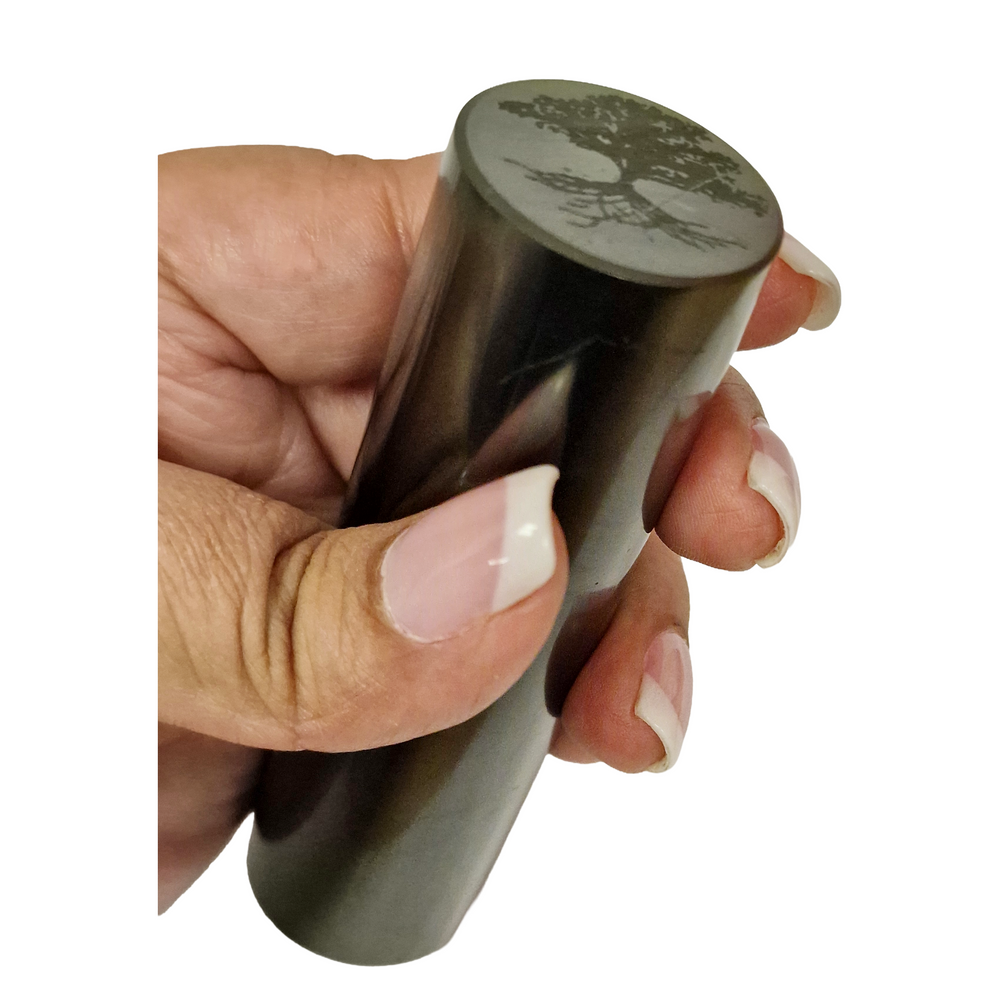 Shungite Cylinder 10cm with Tree of Life and Flower of Life on hand for size reference, grounding and EMF protection