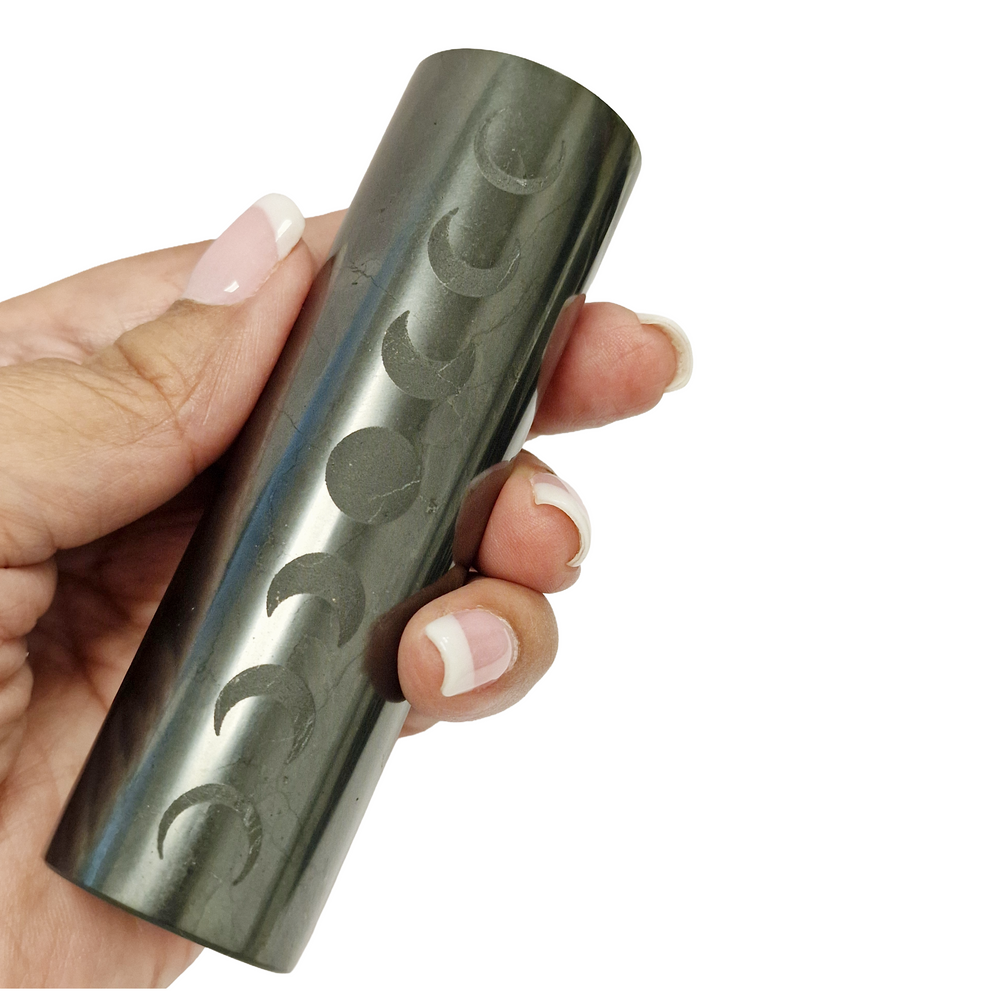 Shungite Cylinder 10cm with moon phase engraving on white background, lunar cycle symbolism for balance and transformation