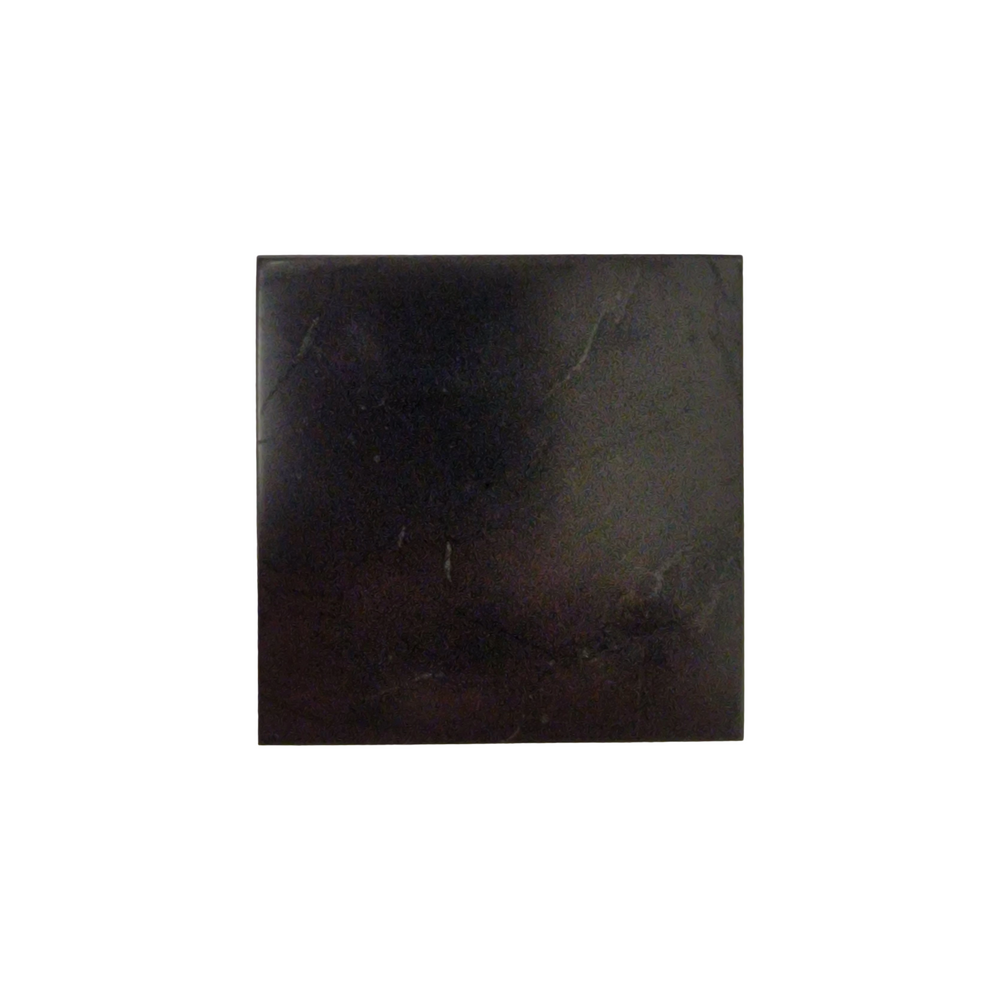 Shungite protective square slice on white background, grounding energy protection tool for laptops