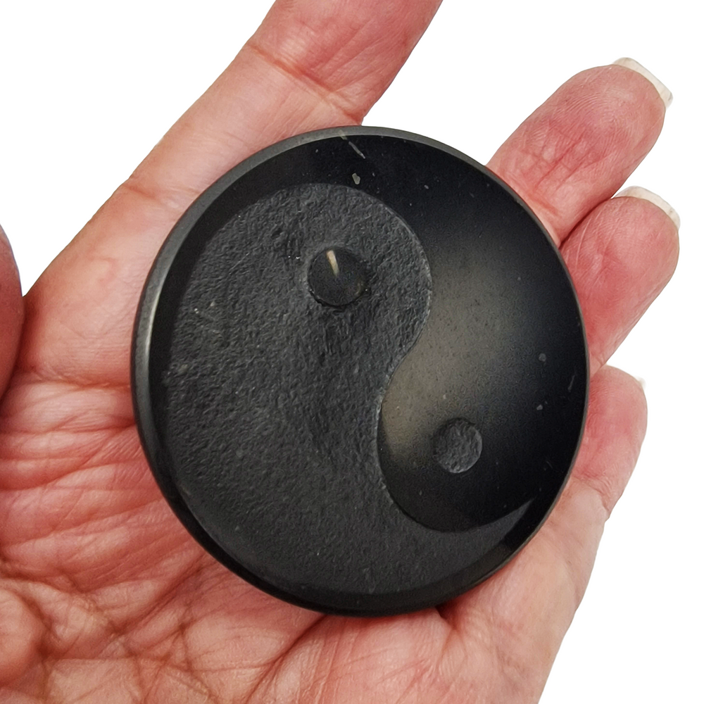 Shungite round 50mm Yin Yang engraved protective slice on hand, grounding and EMF protection crystal