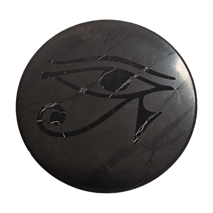 Shungite round 50mm Eye of Horus slice on white background, spiritual protection crystal for electronics