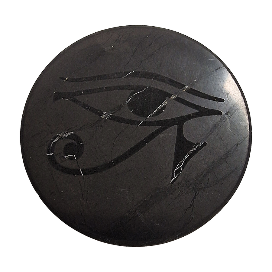 Shungite round 50mm Eye of Horus slice on white background, spiritual protection crystal for electronics