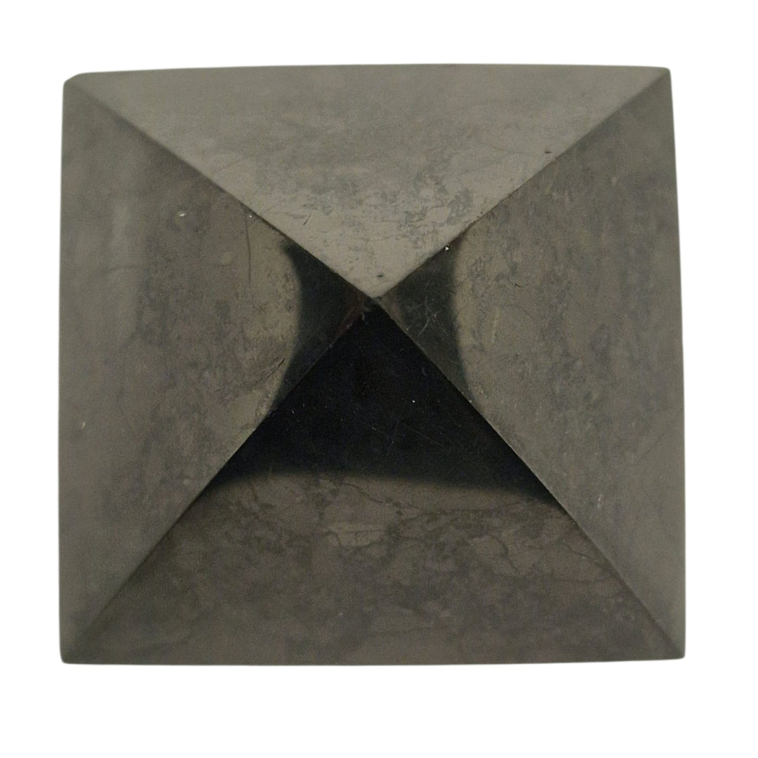 Side view of Shungite 40mm Pyramid on white background, grounding stone for EMF shielding