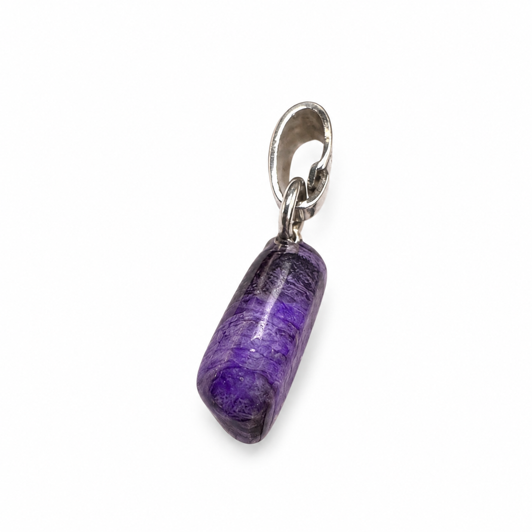 GeoFossils natural Sugilite pendant showing its opposite side profile, with deep violet tones, darker mineral patterning and a polished freeform finish.