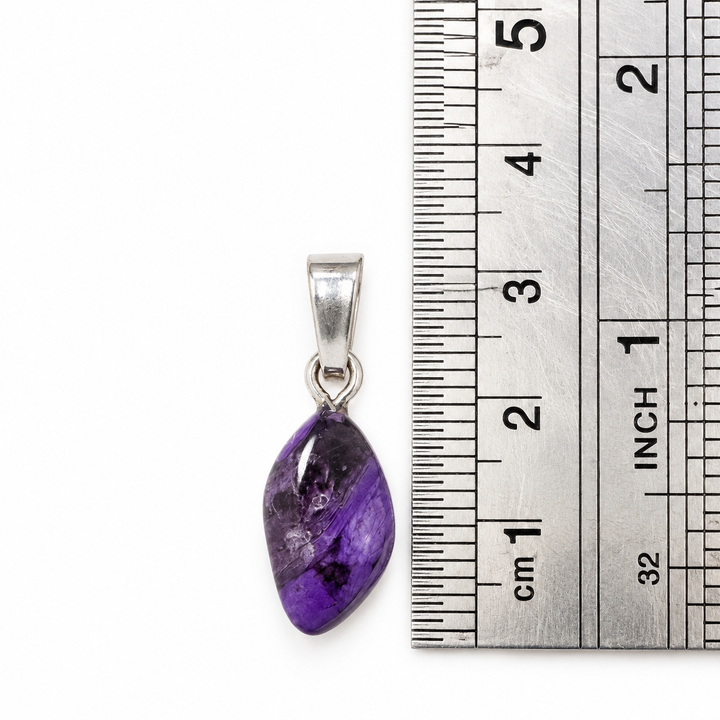 GeoFossils Sugilite pendant positioned beside a centimetre ruler to demonstrate its approximate dimensions, including the sterling silver bail.