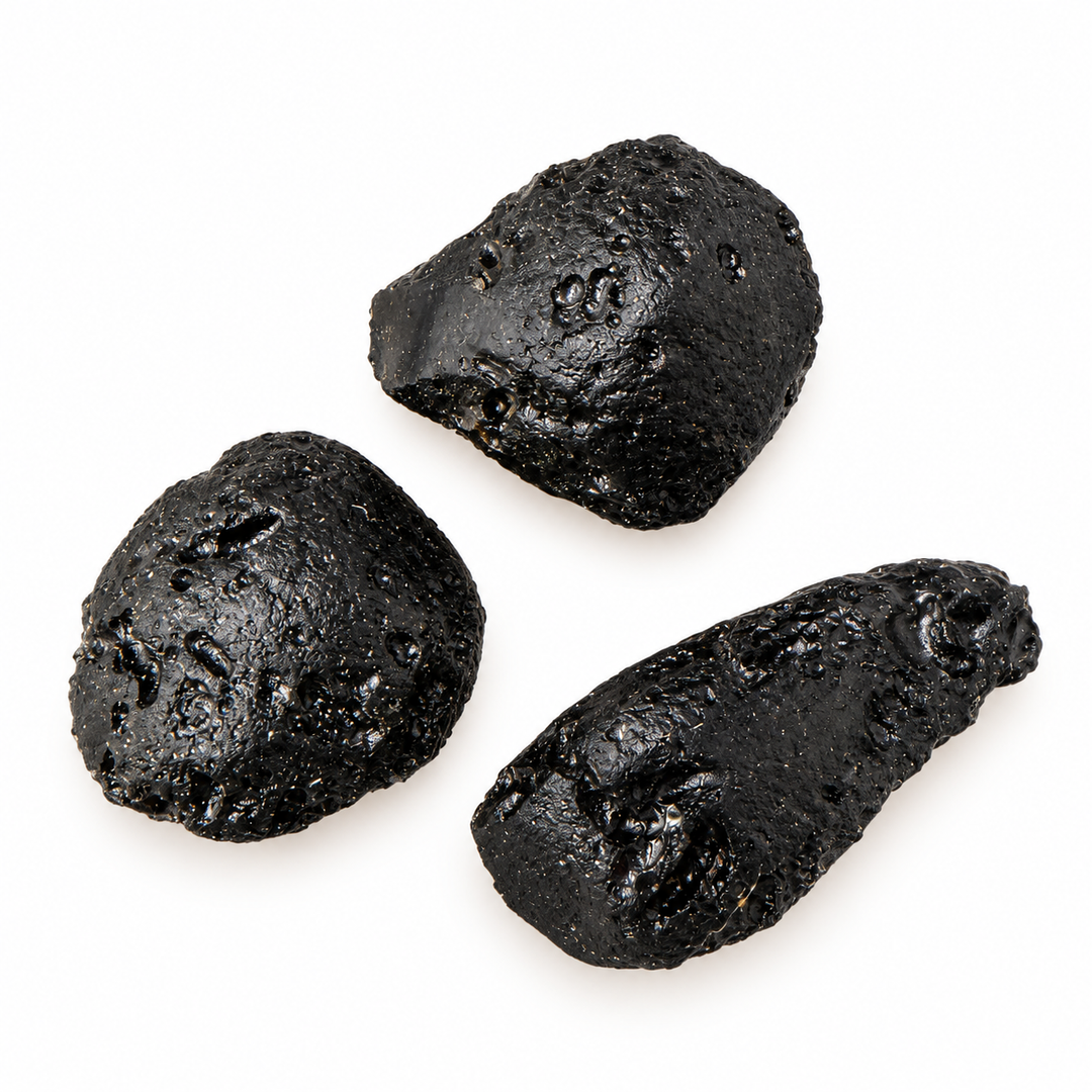 GeoFossils 12g Tibetan Tektite specimens displaying a black surface with pronounced grooves and natural cavities on a white background.