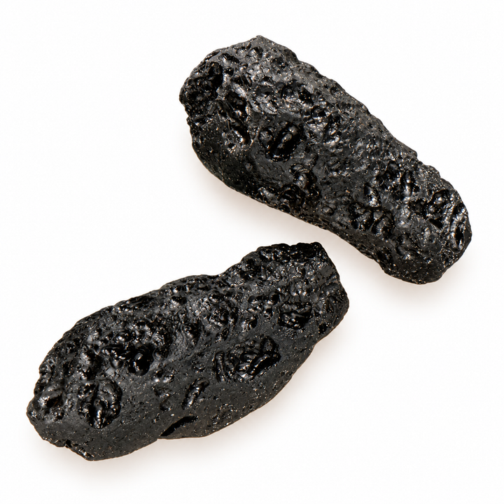 GeoFossils 16g Tibetan tektite specimens featuring an elongated shape, dark glassy texture and natural surface grooves.