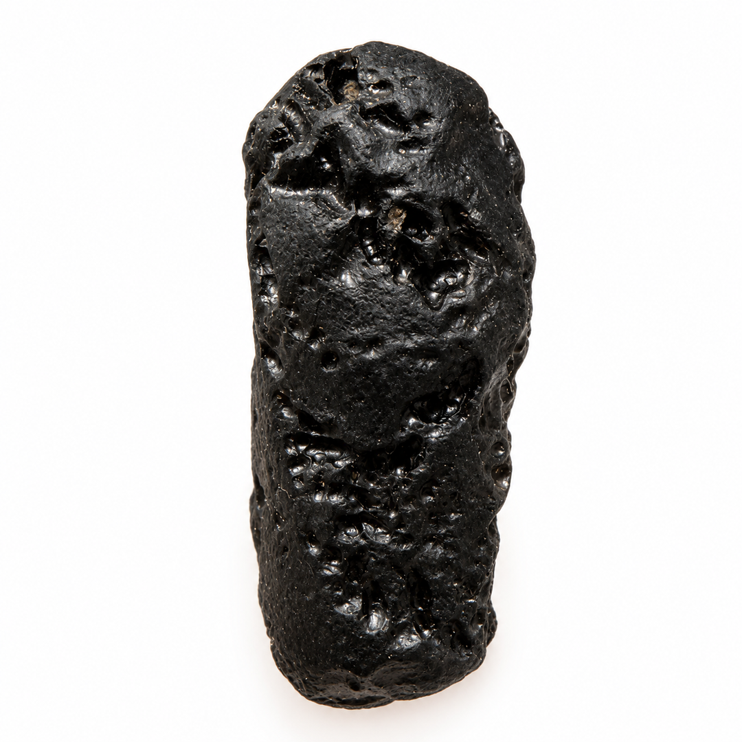 GeoFossils 22g Tibetan tektite specimen featuring a dark glossy surface, rounded contours and distinctive natural cavities.