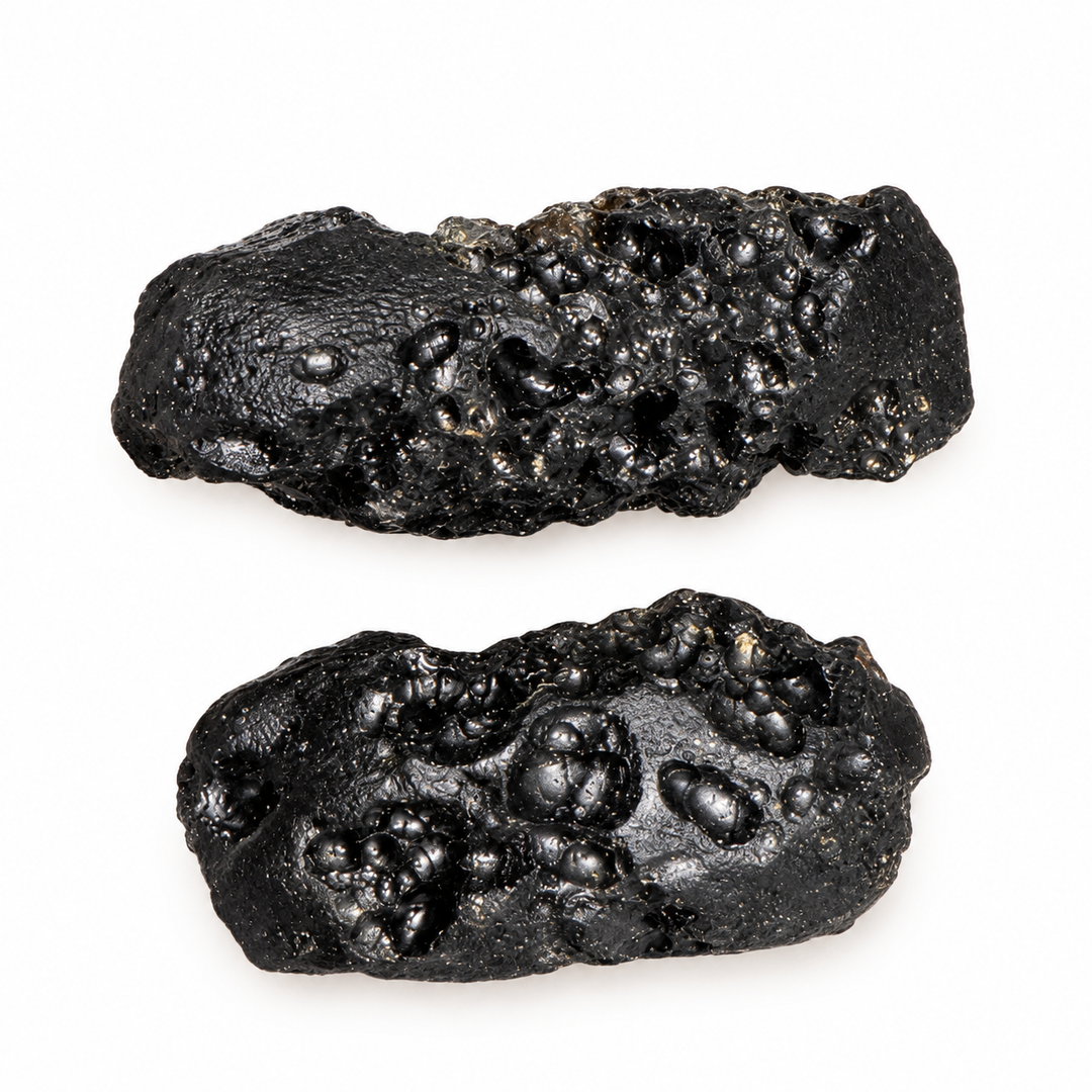 GeoFossils 7g Tibetan Tektite specimens featuring an irregular shape and distinctive surface cavities on a white background.