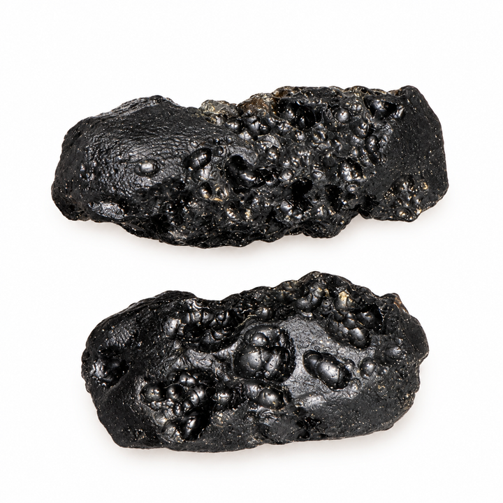 GeoFossils 7g Tibetan Tektite specimens featuring an irregular shape and distinctive surface cavities on a white background.