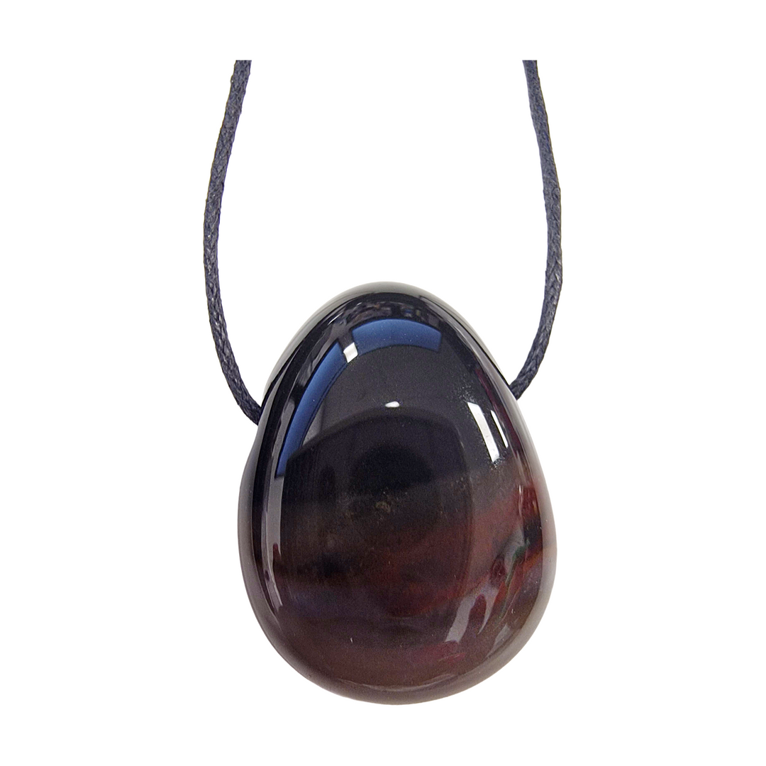 Polished Sardonyx drilled tumble stone on a black vegan cotton cord, displaying bold banded layers of red, brown, and cream for strength and grounding energy.