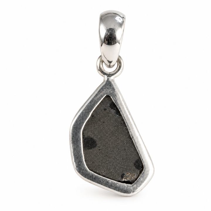 GeoFossils Uvarovite Garnet pendant photographed from the back, showing the dark mineral backing, polished silver bezel setting and sterling silver bail.