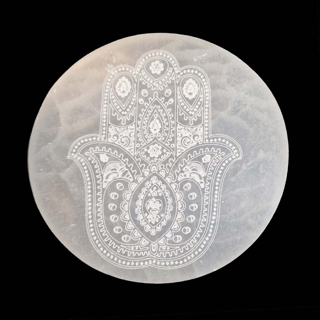 Selenite Hamsa Hand Charging Disc by GeoFossils – 15cm round, smooth, white selenite disc with engraved Hamsa symbol, ideal for crystal charging, protection, and spiritual cleansing.