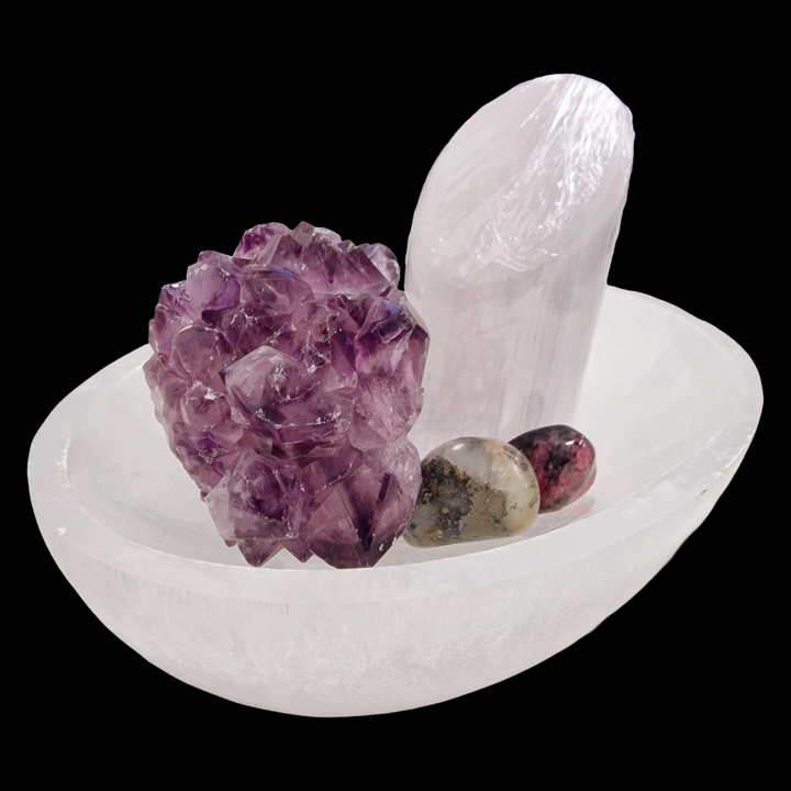 Selenite Oval Charging Bowl 10 cm shown on black background.